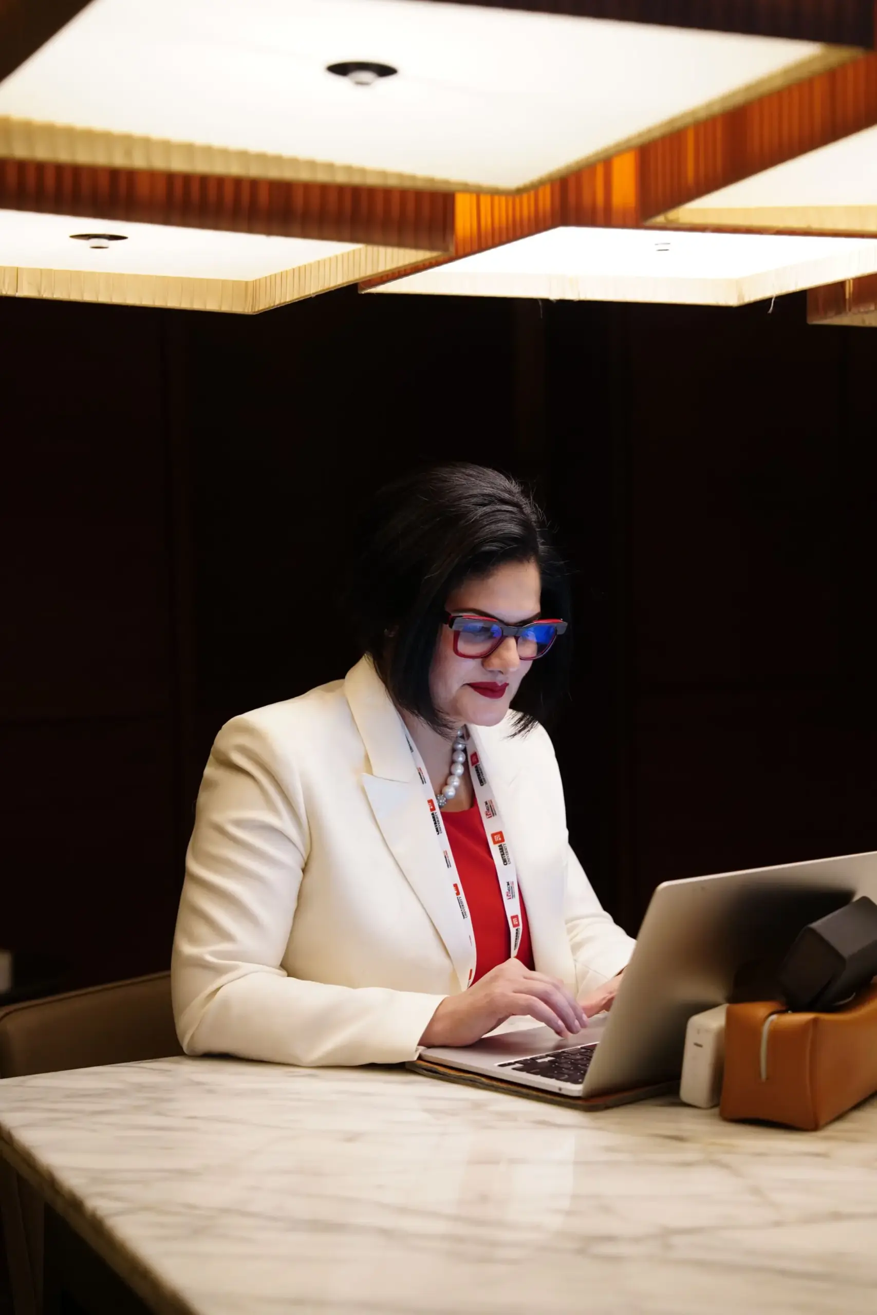 Indian businesswoman working on a laptop in a professional office