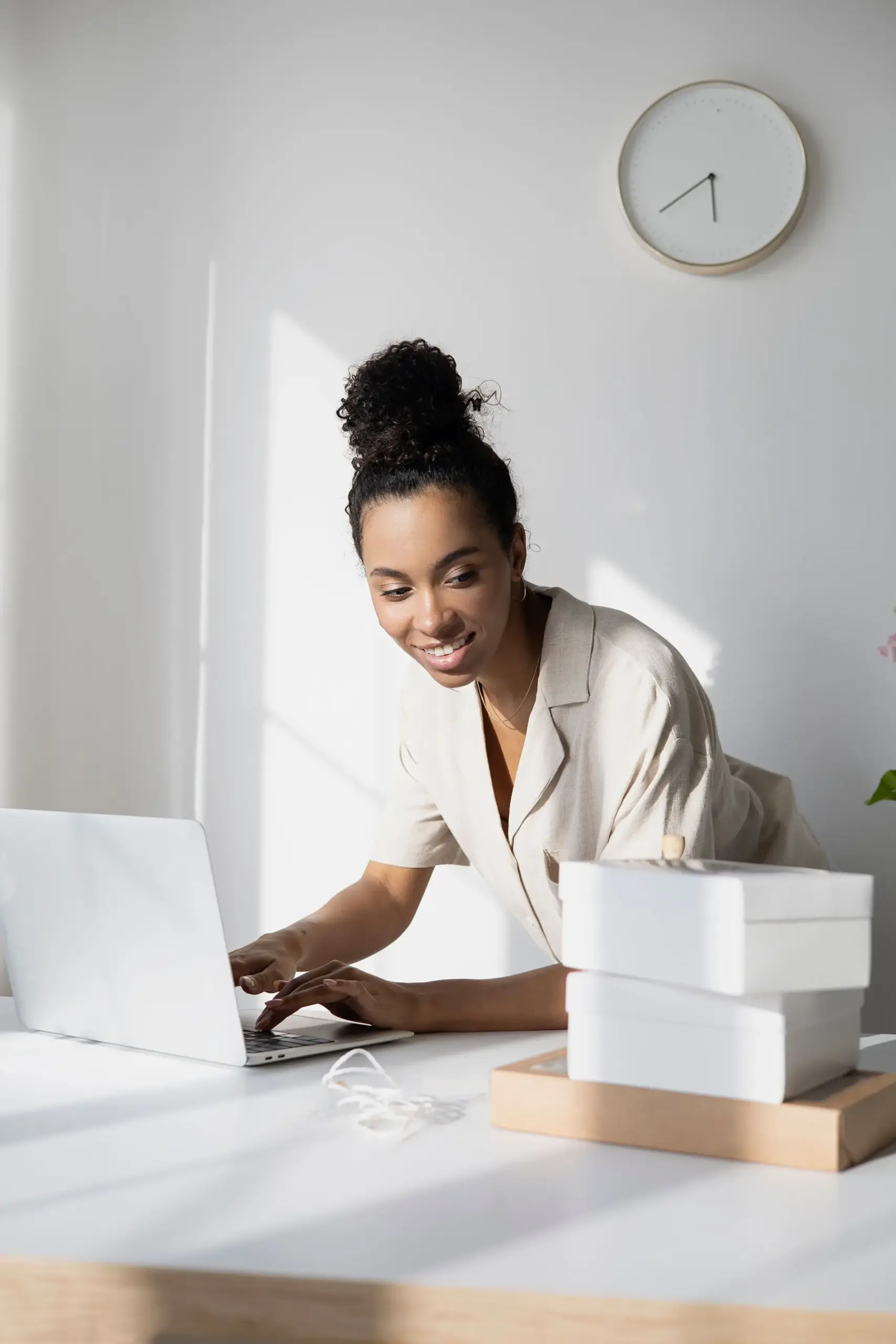 Businesswoman using a laptop in a bright professional workspace